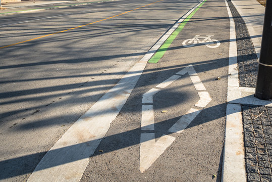 Fototapeta Symbols on Asphalt of a Bicycle Lane along an Empty Street in Downtown Toronto