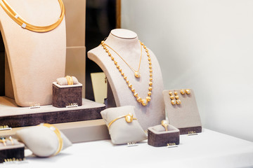 Golden jewelry in shop window display