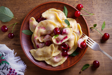 Dumplings with cherries. Pierogi, varenyky, vareniki, pyrohy - dumplings with berry filling....