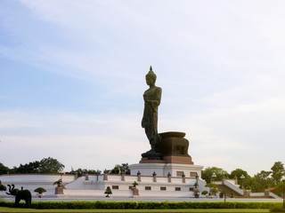 Fototapeta na wymiar Buddha Statue sky background, Buddhist park Phutthamonthon.