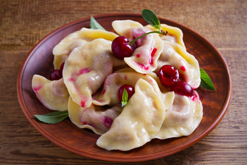 Dumplings with cherries. Pierogi, varenyky, vareniki, pyrohy - dumplings with berry filling. horizontal