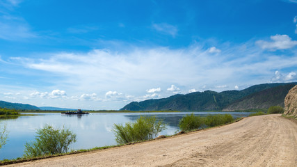 A ferry on the Selenga River - the largest inflow of Lake Baikal in the vicinity of the village of...