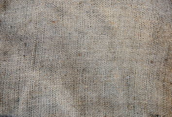 Old vintage linen cloth textile. Burlap rustic tumbled texture background.