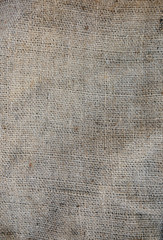 Old vintage linen cloth textile. Burlap rustic tumbled texture background.