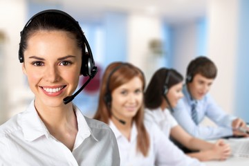Beautiful businesswoman portrait  with headset , colleagues on