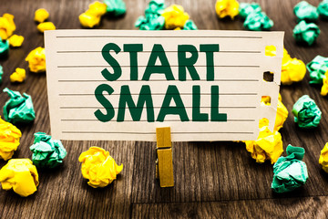 Text sign showing Start Small. Conceptual photo Small medium enterprises start up Business entrepreneurship Clothespin holding notebook paper crumpled papers several tries mistakes.