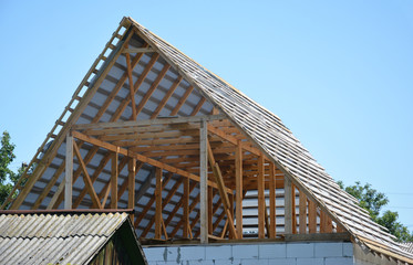 Building house attic roof construction with trusses, wooden beams, waterproofing memmbrane.