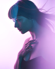 Profile of girl on purple and pink light