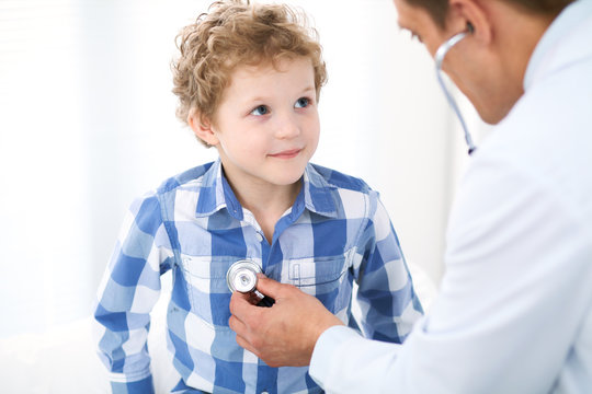 Doctor and child patient. Physician examines little boy by stethoscope. Medicine and children's therapy concept