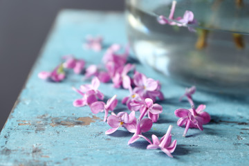 Beautiful lilac flowers on table, closeup