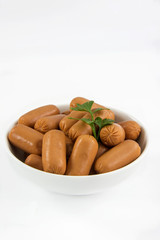 Raw appetizer sausages served in a bowl