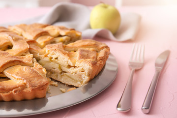 Plate with delicious apple pie on table, closeup