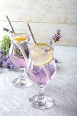 Glasses with fresh lavender lemonade on table