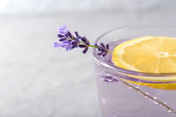 Fresh lavender lemonade in glass on light background, closeup