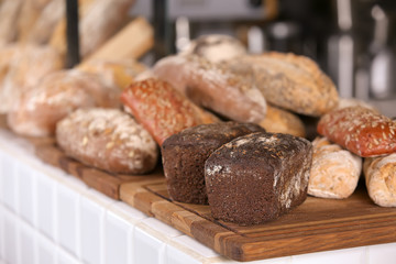 Assortment of fresh bread on counter in bakery