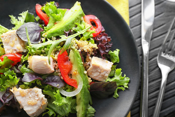Tasty chicken salad with vegetables on plate, closeup