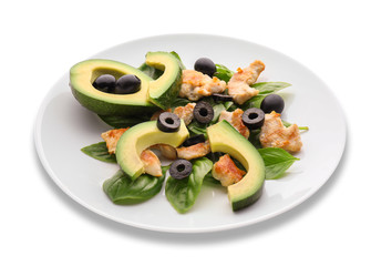 Salad with ripe avocado on plate against white background