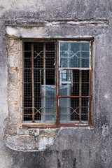 Old broken window on an abandoned old building