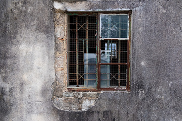 Old broken window on an abandoned old building