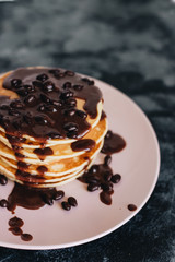 Stack of delicious homemade pancakes with sauce
