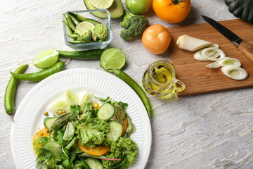 Plate with healthy vegetable salad on table