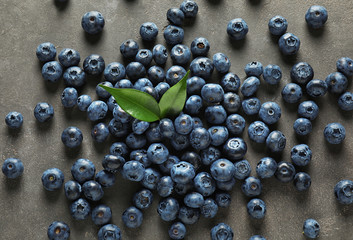 Ripe blueberries on grey background
