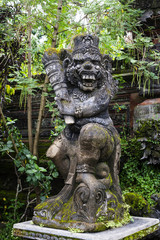 Statue of old stone cruel monkey Hindu temple, Ubud, Bali