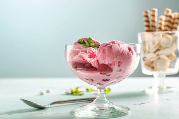 Dessert bowl with tasty raspberry ice-cream on table