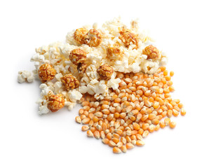 Delicious popcorn and kernels on white background