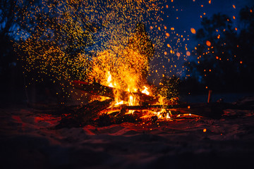 Beach Bonfire with sparks flying around