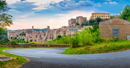 Fototapeta na wymiar Panorama of the picturesque medieval village of Sorano located on a hill at sunset, Tuscany. Italy