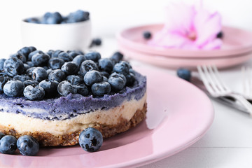 Delicious cheesecake with blueberries on plate, closeup