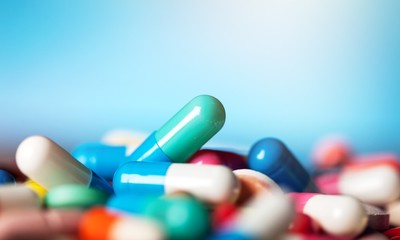 Colorful pills and tablets on background