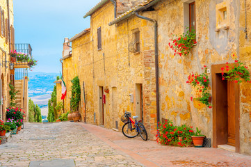 A street in the beautiful little village of San Gimignano with a view of the Tuscan valley. Italy....