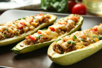 Meat stuffed zucchini boats on plate, closeup