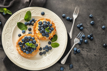 Delicious blueberry tarts on plate