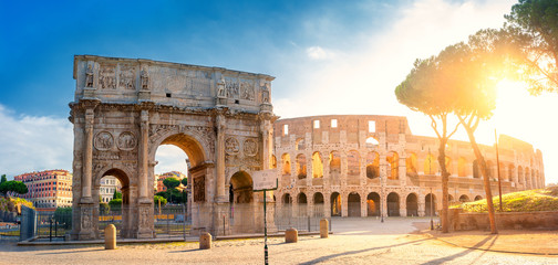 Panorama of the Arch of Constantine and the Colosseum in the morning sun. Rome architecture and...