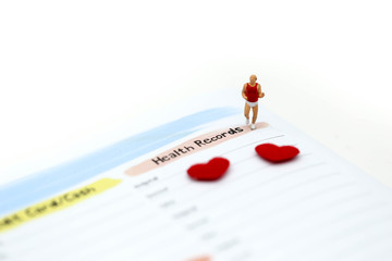 Miniature people : marathon runners with glucose meter with lancet and mini heart, jogging and running,medicine, diabetes, health care concept.