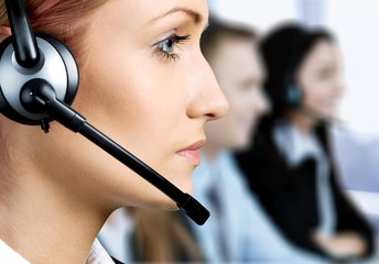 Female call center employee with coworkers on background