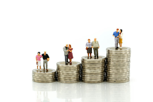 MIniature people : Couple in love standing on stack of coin. Money, Love and Valentine's day concepts.