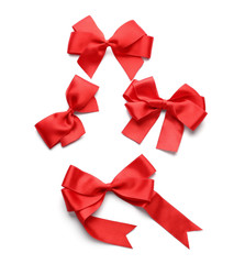 Beautiful bows from red ribbons on white background