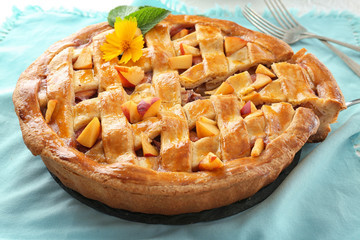 Tasty homemade peach pie on table
