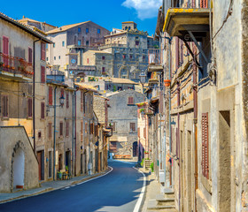 Fototapeta premium A street in the medieval town of Bomarzo, a castle over the city on a hill. Italy. Europe