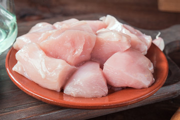 pieces of uncooked raw chicken on rustic wood