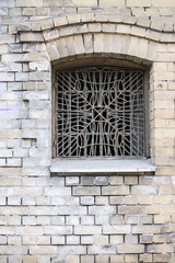 Fragment of vintage brick wall with window. Textural background. Riga, Latvia