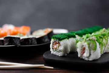 Sushi restaurant menu, Japanese traditional food. Tasty appetizing rolls set with wide assortment of fillings, close up with copy space