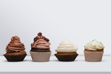 Tasty Colorful cupcakes on background
