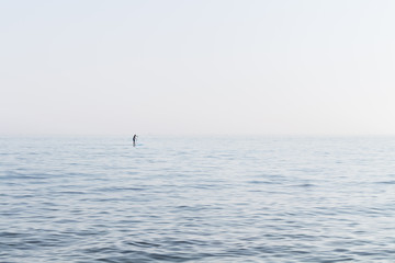 Naklejka premium Stand Up Paddler on the open Sea