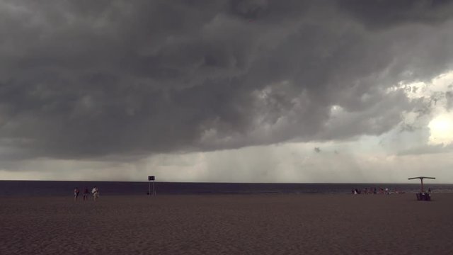 Incoming storm on the beach. Time lapse