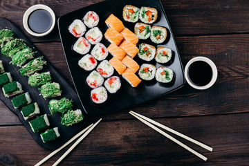 Japanese food, dinner at restaurant, traditional cuisine. Variety of tasty multicolored sushi rolls, flat lay